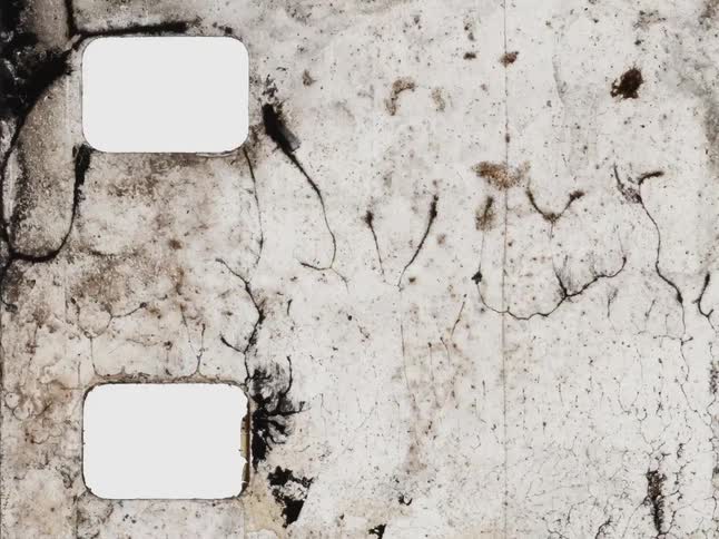 Abstract grunge background featuring a damaged and melting vintage film strip in stop-motion