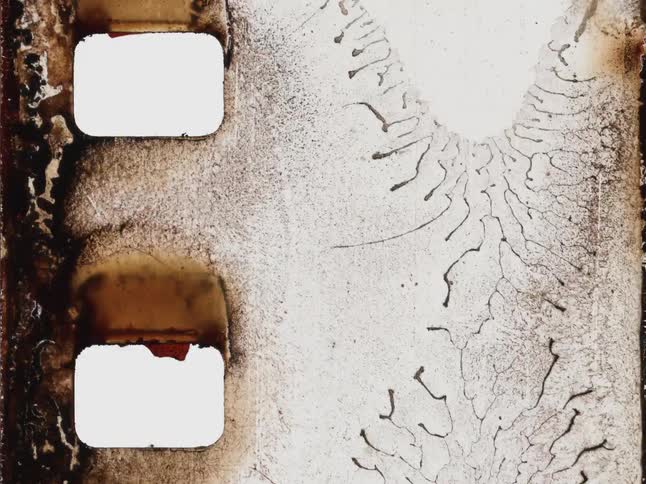 An abstract stop-motion animation showcases a grungy, decaying vintage film strip with visible damage