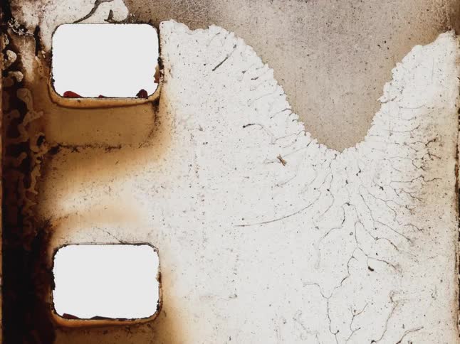 Stop motion animation of a close-up, damaged, and decaying old film strip with sprocket holes
