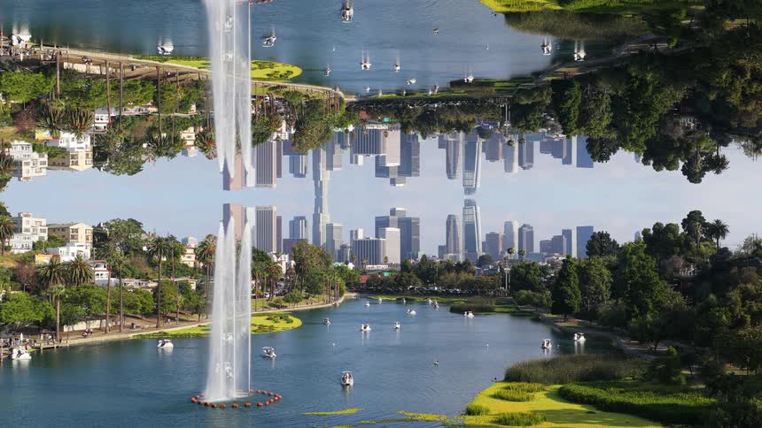 An abstract mirrored landscape of Echo Park in Los Angeles with its fountain and the downtown skyline creating a surreal, symmetrical world