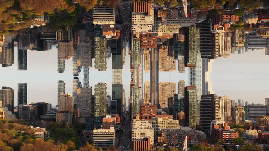 A surreal and abstract mirrored cityscape of a major metropolis pulls back slowly at golden hour, creating a kaleidoscopic, dreamlike effect