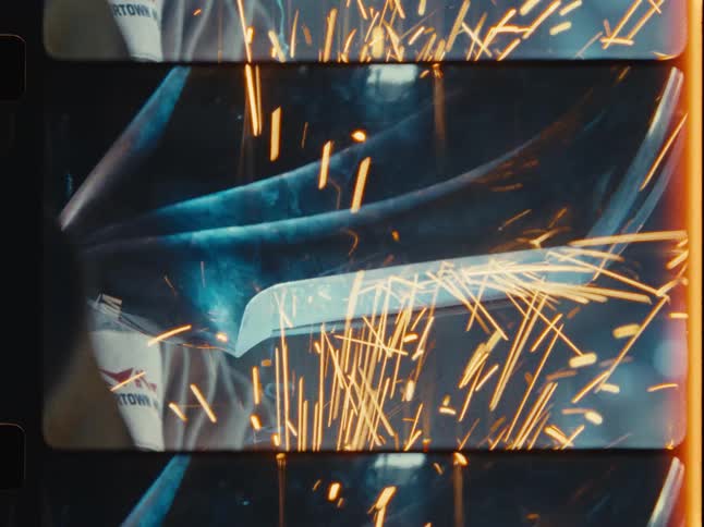 Close-up shots of a welder working on a metal project in a workshop, captured on vintage film with light leaks