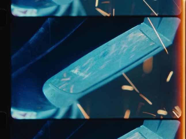 Dramatic close-up of industrial welding with flying sparks, captured in a vintage film strip aesthetic