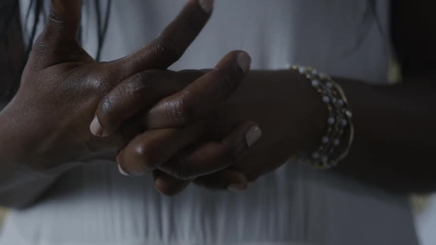 A woman wrings her hands