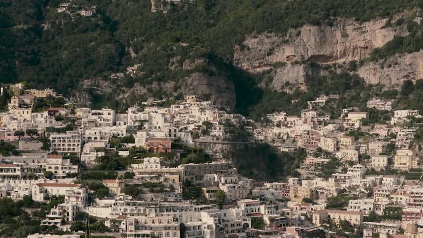 A slow zoom-out shot captures the iconic cliffside village of Positano on the beautiful Amalfi Coast in Italy