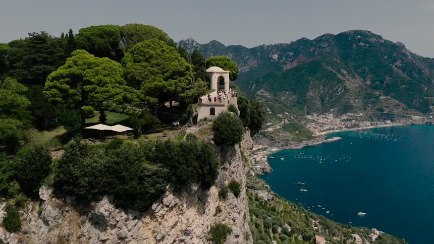 Aerial drone shot slowly approaches the iconic Terrace of Infinity at Villa Cimbrone in Ravello, Italy, revealing the stunning Amalfi Coast