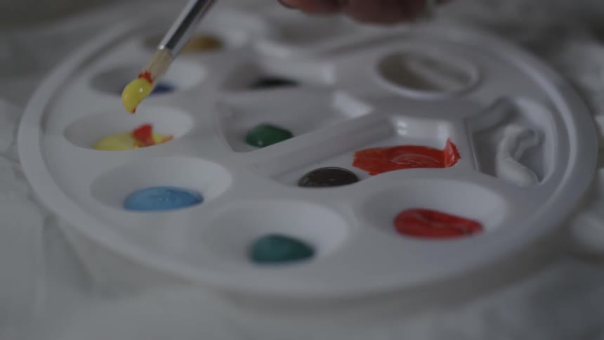 The paint is being mixed in the palette