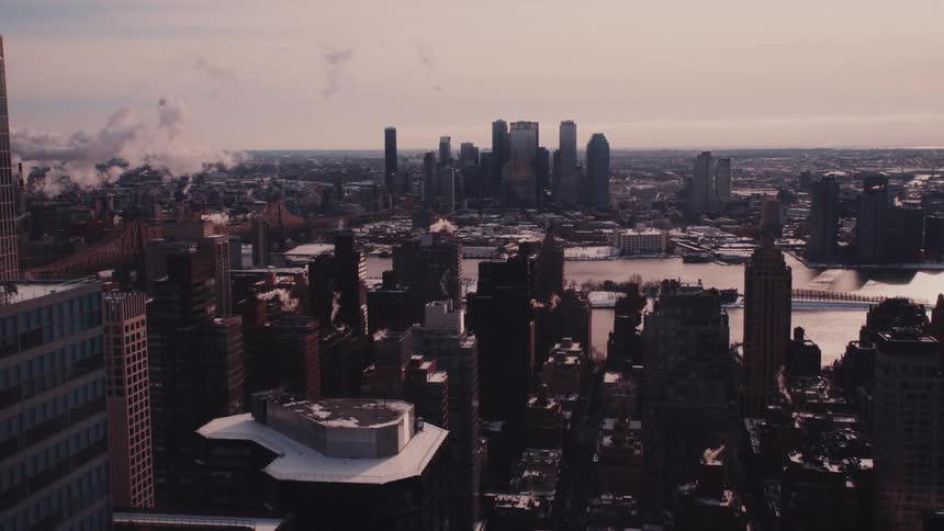 A wide shot of the New York City skyline on a cold winter day at sunset