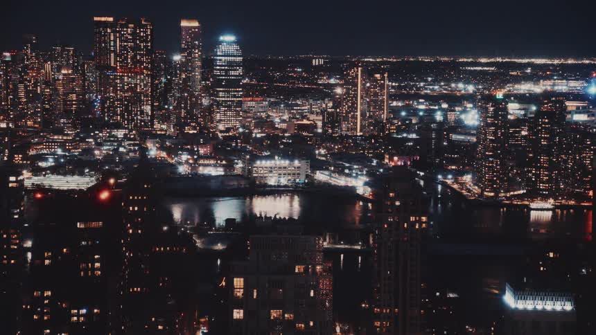 A sparkling animated still of a sprawling city skyline with shimmering lights at night