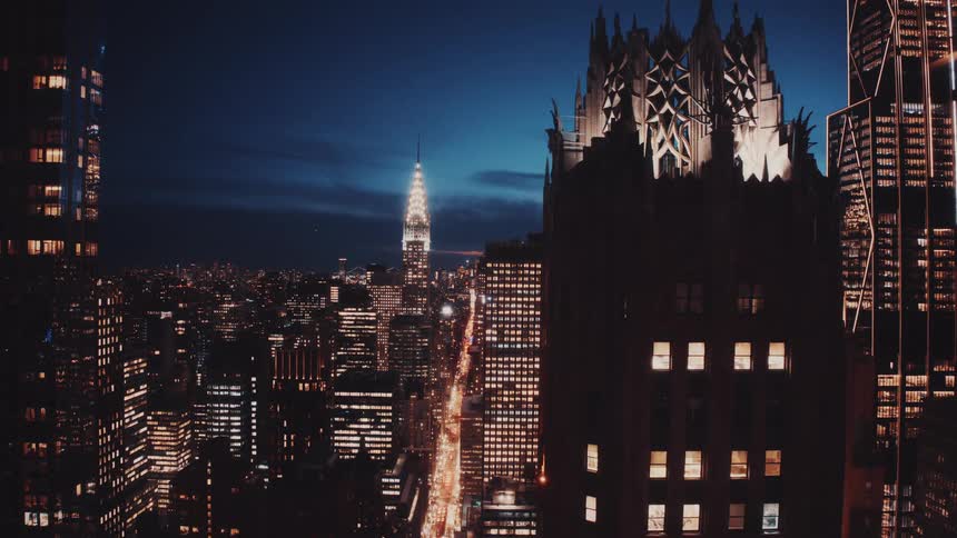 Stunning time-lapse view of the bustling New York City skyline at night with iconic skyscrapers and streaks of traffic lights