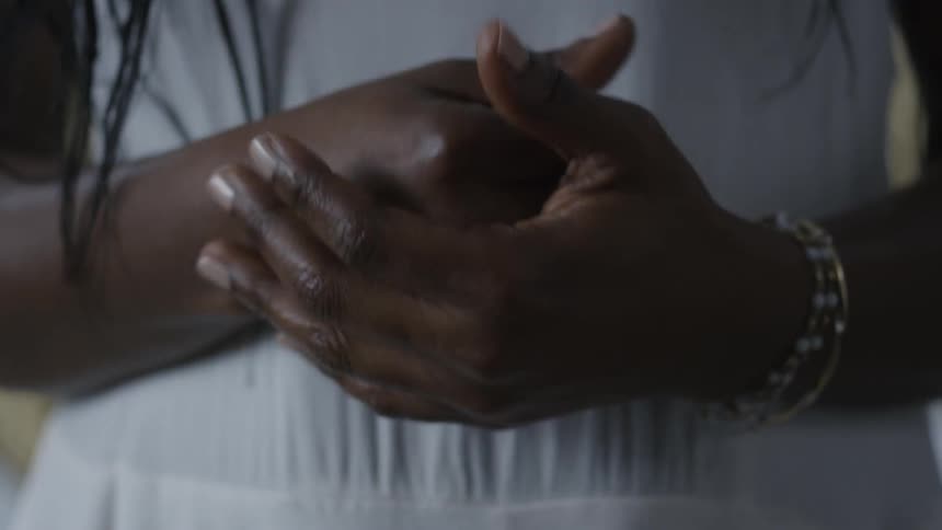 Two hands clasping and unclasping