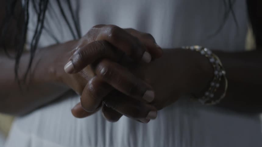 A person is clasping their hands