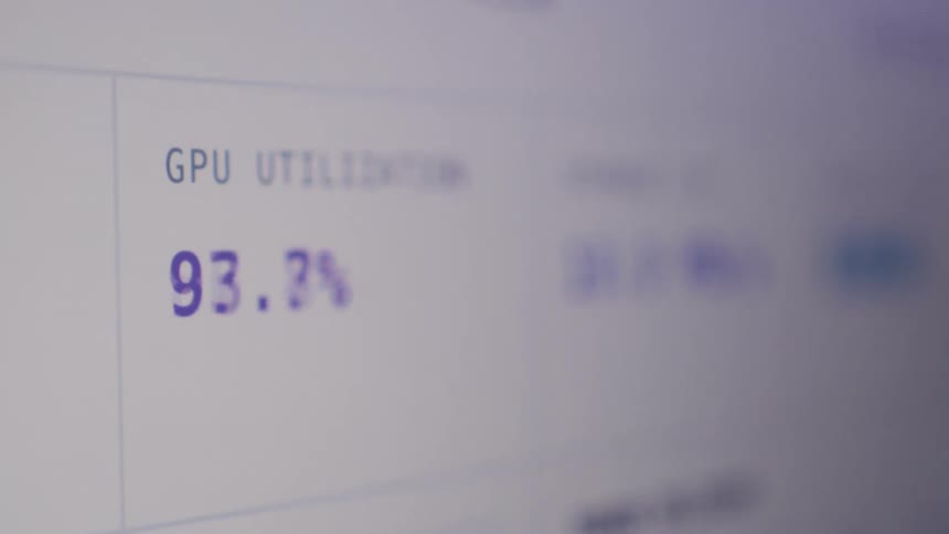 A close-up of a computer monitor displays fluctuating real-time data for high-performance storage I/O and GPU utilization