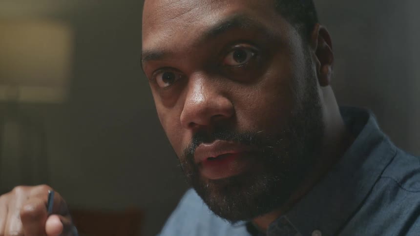 Slow motion close-up of a man's smiling face turning to an expression of utter shock
