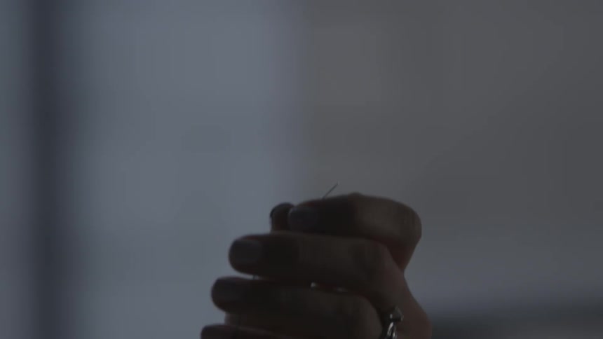 A person lifts a needle up