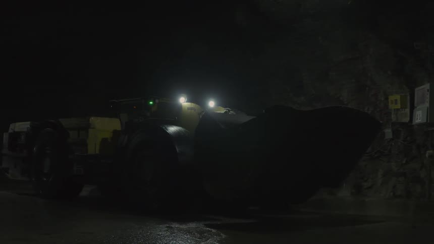 A bulldozer drives in a tunnel