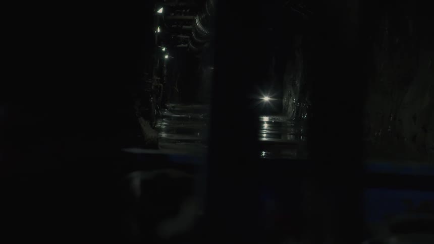 Light shines from a vehicle in the tunnel