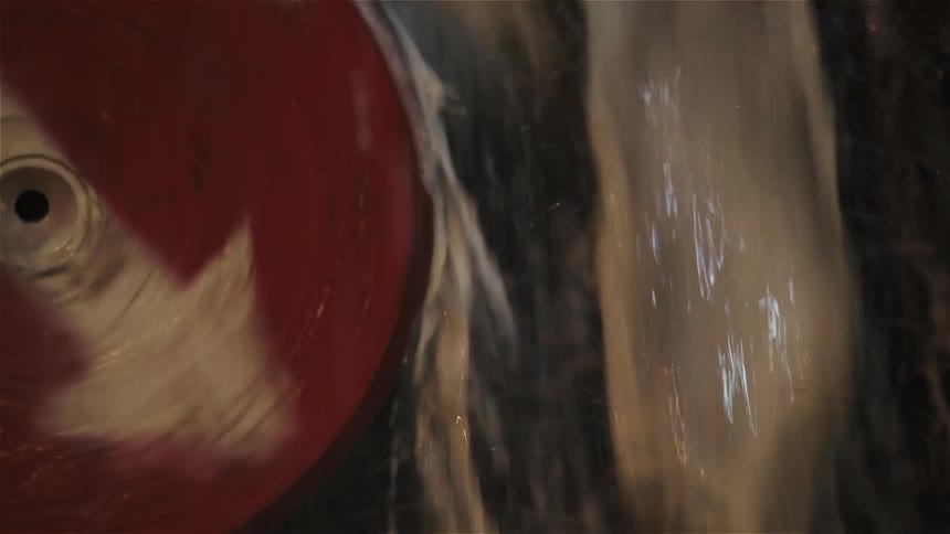 Spinning wheel with water splashing off of it