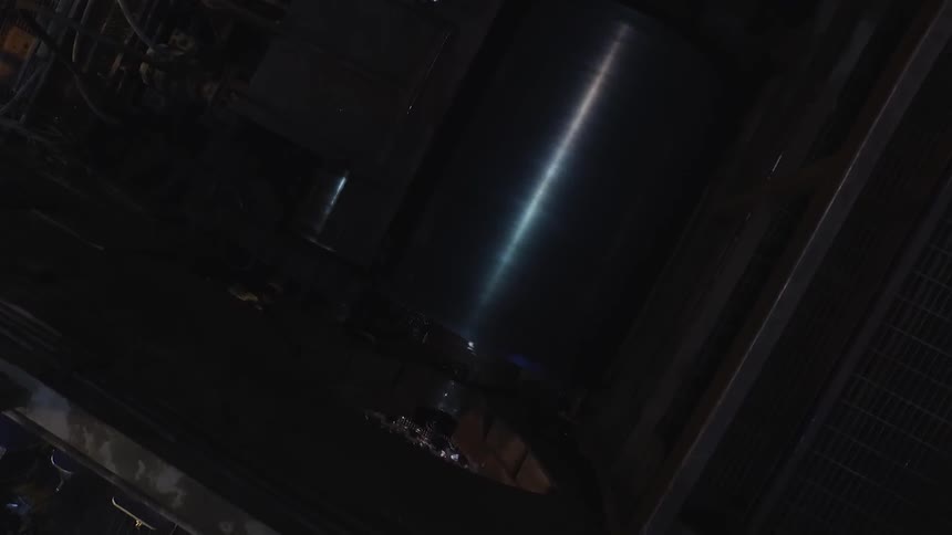 A cylinder rotates inside a piece of machinery