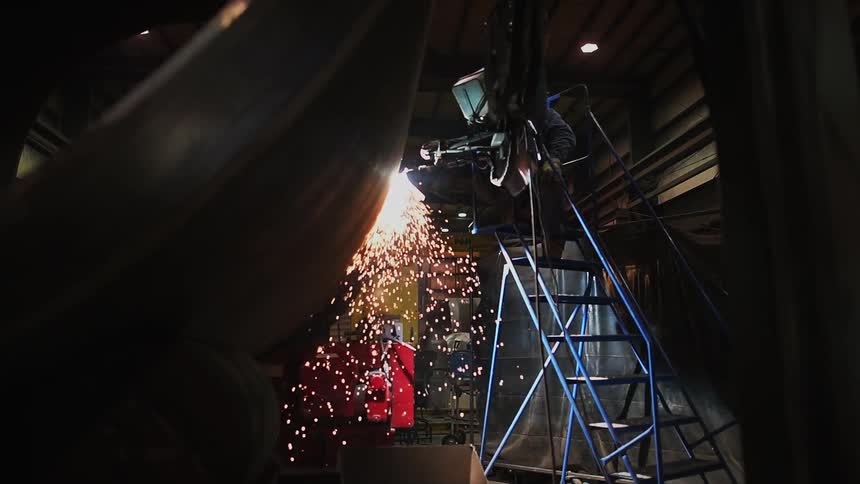 Person welds a large tank