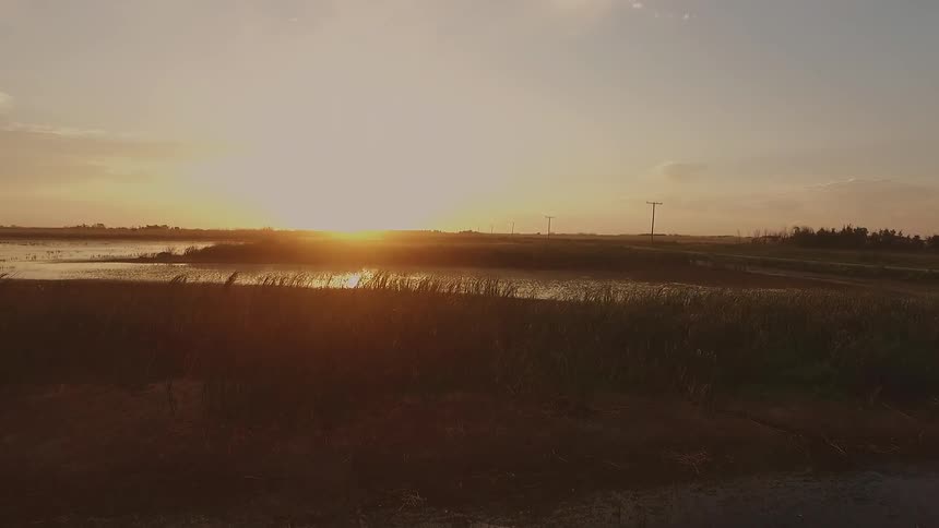 The sun sets over a lake