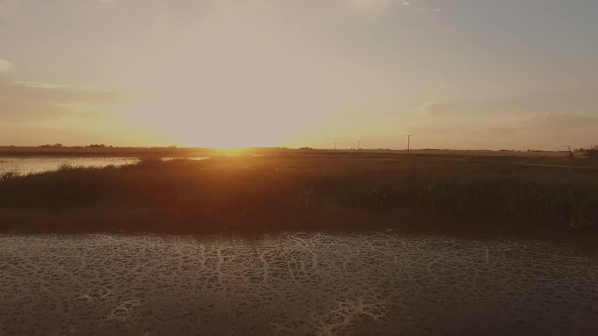The sun sets over a lake