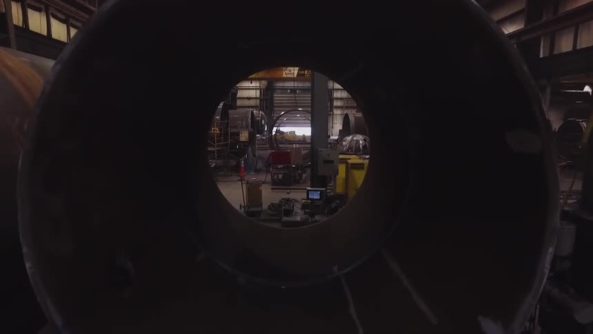 A zooming in view of a building with a large tube and moving through the tube