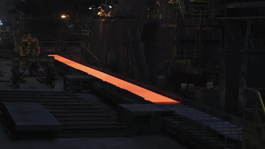 Molten looking sheet rolling on a conveyor belt
