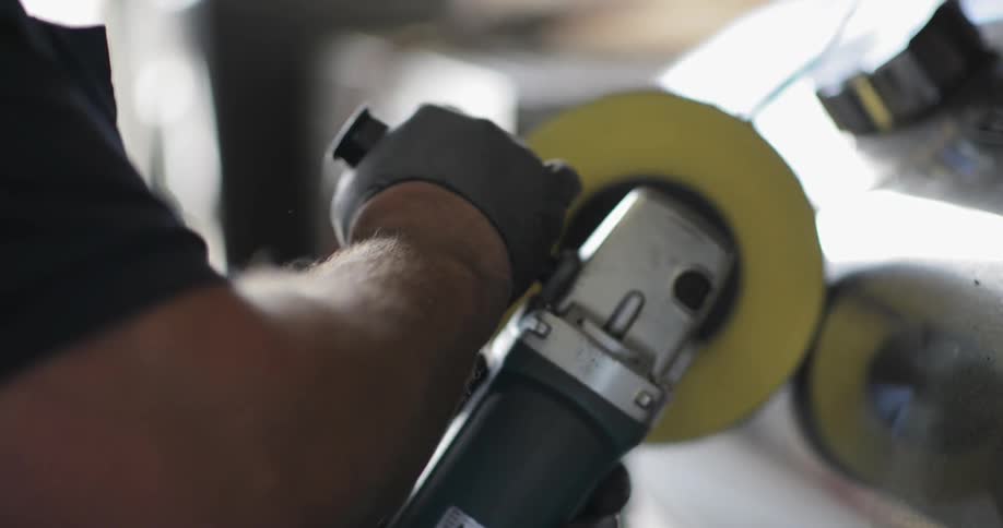 A man is using a large circular sander