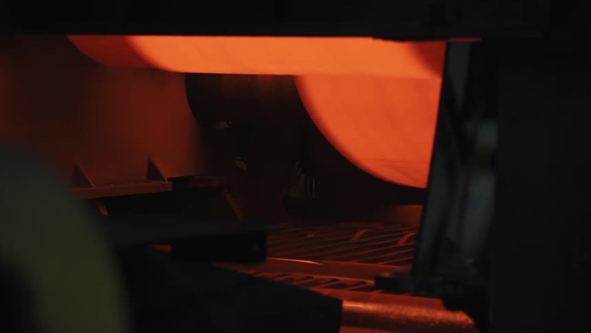 The machine has rollers that are red hot