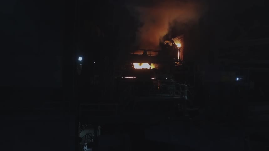 Smoke and fire billowing out of machines in a factory