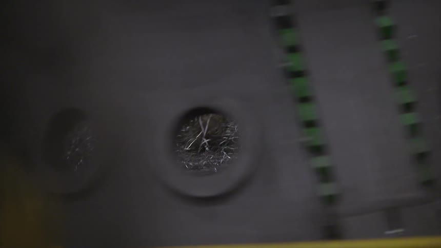 Close up of a machine and view through holes to the ground