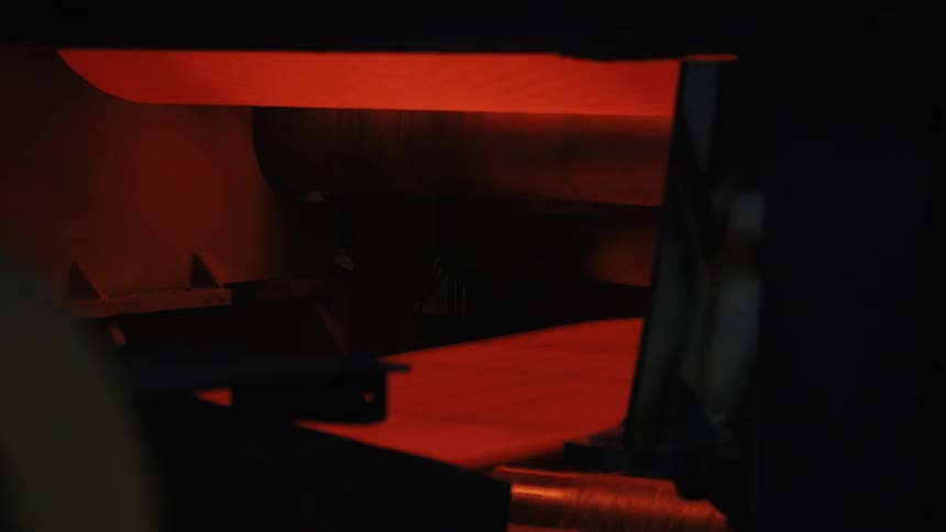 Molten looking sheet rolling on a conveyor belt