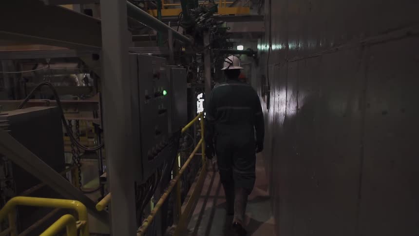 A man travels down a railing in a workplace