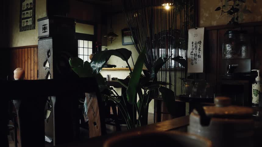 A tranquil and moody interior of a traditional Japanese restaurant filled with vintage wooden decor
