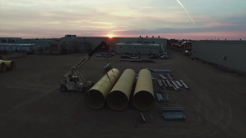 Large tubes and metal in an industrial yard