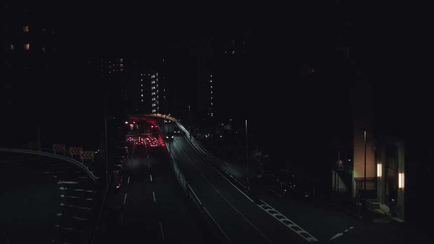 High angle view of cars driving on a city highway in the darkness of night