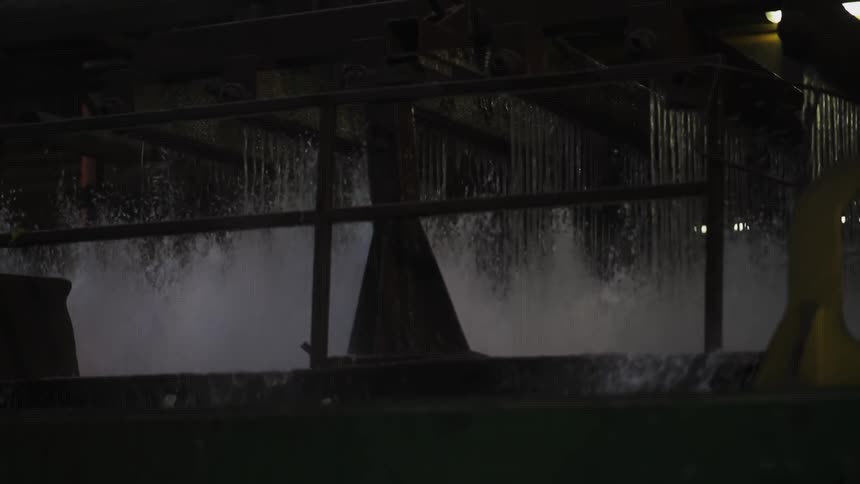 The water rushes around in the dark