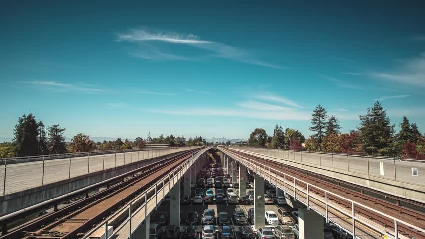 Cars drive over bridges on a sunny day