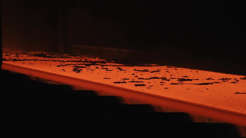 Molten material flows through factory machinery