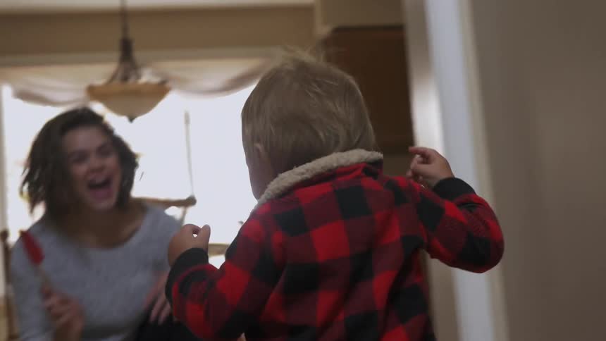 Toddler runs to a smiling woman