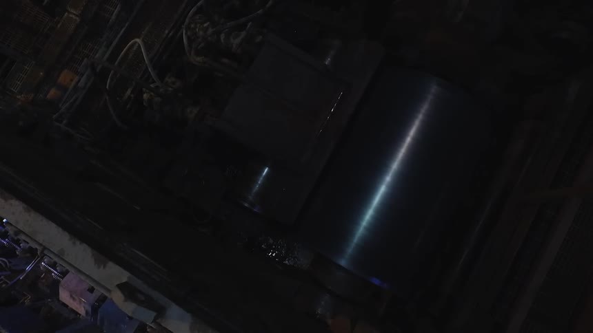 A cylinder rotates inside machinery