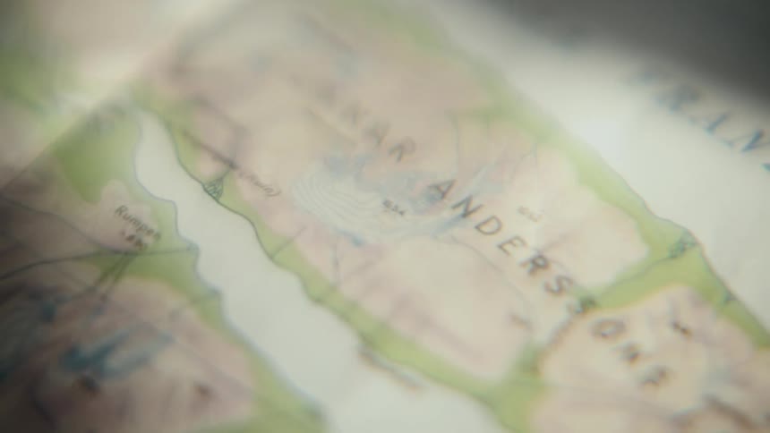 Ethereal close-up of a topographical map with the name 'Gunnar Anderssons', creating a mysterious and nostalgic mood