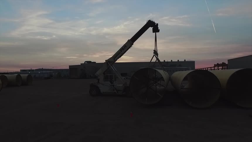 A crane is attached to a large tube