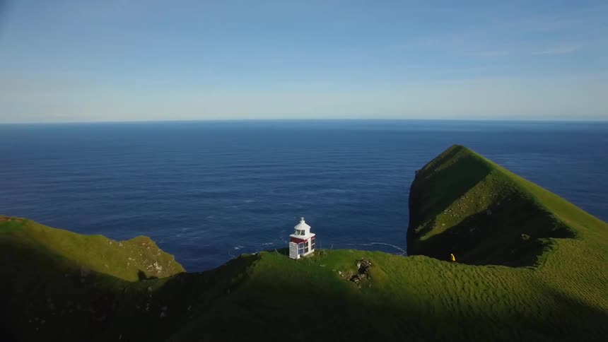 A building sits on a seaside cliff
