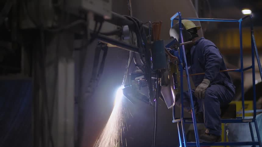 Person welds a large tank