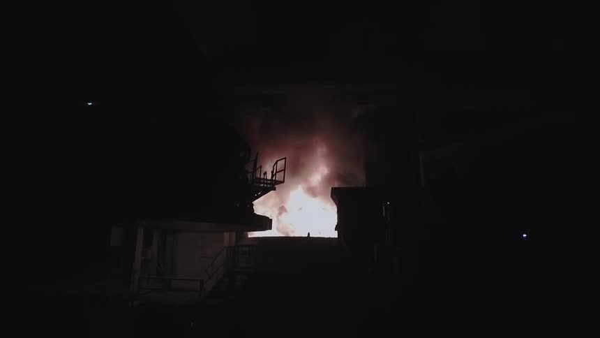 A fire blazes in the dark ahead