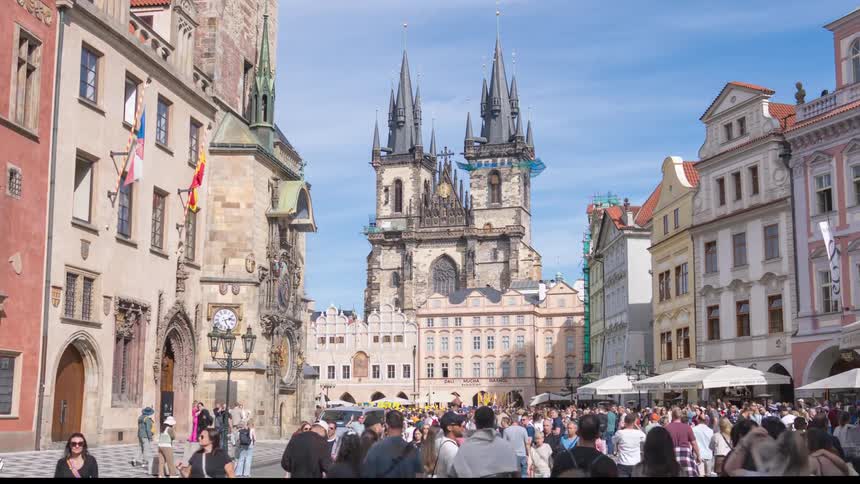 Hyper-lapse moving through the crowded Old Town Square in Prague, Czech Republic, featuring the famous Týn Church and Astronomical Clock