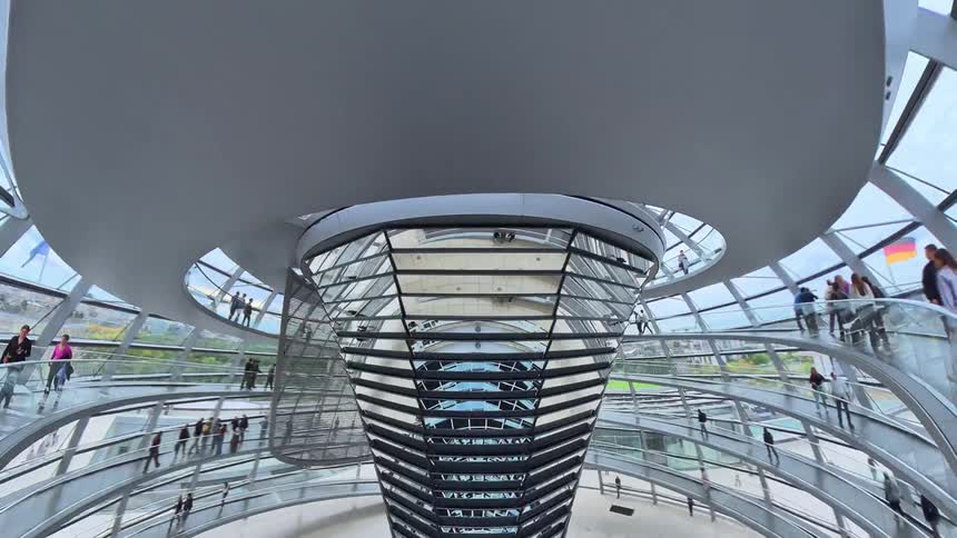 A dynamic time-lapse journey inside the iconic glass dome of the Reichstag Building in Berlin, as tourists ascend the spiral ramp