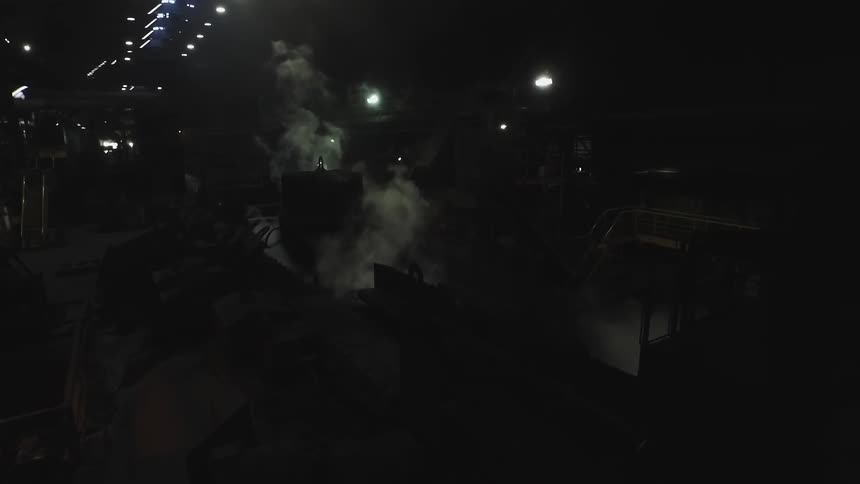 The tunnel is dark with smoke rising from machines